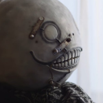 Yoko Taro com máscara de personagem de NieR